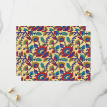 A vibrant textile art piece featuring bold red, ye