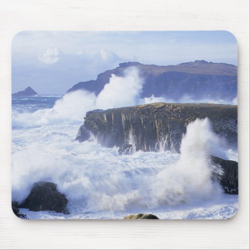 a view of the waves crashing against rocks mouse pad