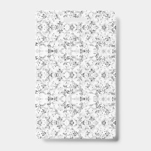 A visually striking white and black patterned wall badge