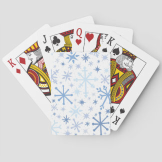 A whimsical flurry of blue snowflakes on white poker cards