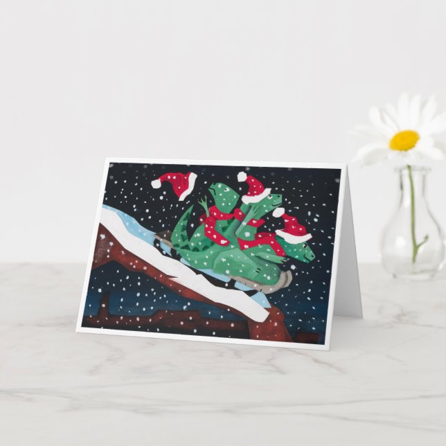 A whimsical holiday card with sledding dinosaurs (Small Plant)