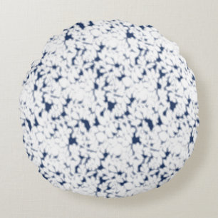 a white and blue background with a pattern round pillow