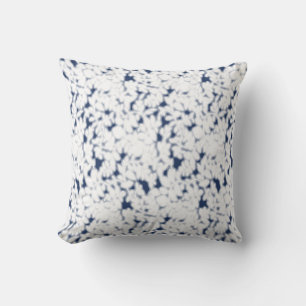 a white and blue background with a pattern throw pillow