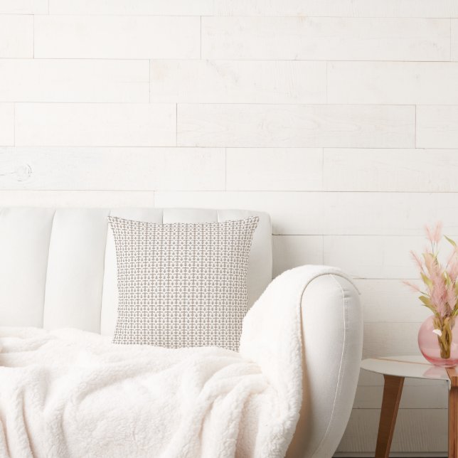a white background with a brown pattern on it throw pillow (Couch)