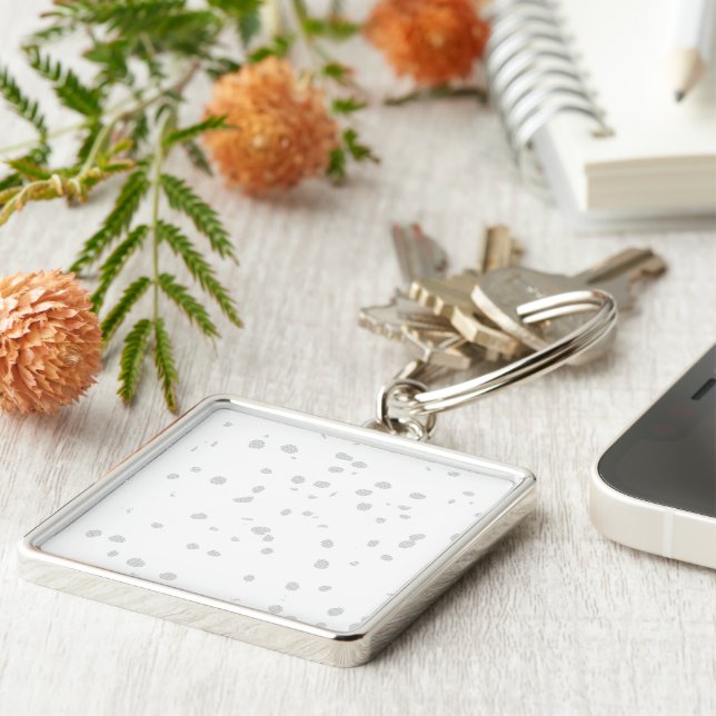 a white background with a lot of small dots keychain (Side)