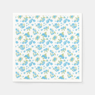 a white background with blue flowers and green lea napkins