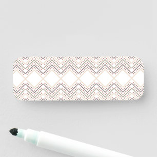 a white background with brown and red dots name tag