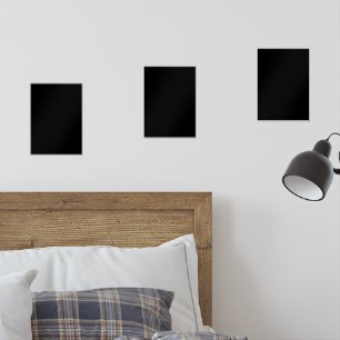 A white clock displayed prominently against a soli wall art sets