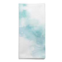 A white cloth napkin with a watercolor design