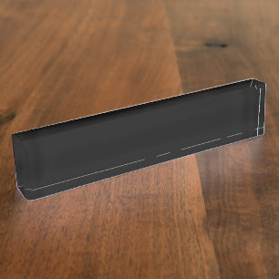 A white full moon shines brightly against a dark n desk name plate