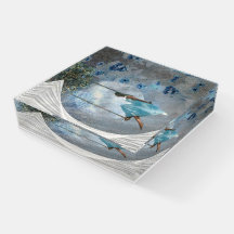 A woman in a blue dress on a swing