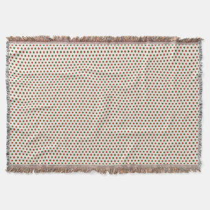 A woven blanket with a red and green polka dot