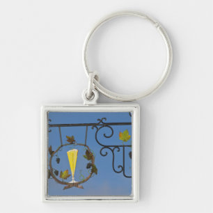A wrought iron sign that illustrates the theme keychain