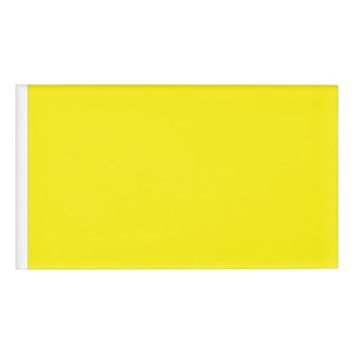 a yellow background with a black border name tag