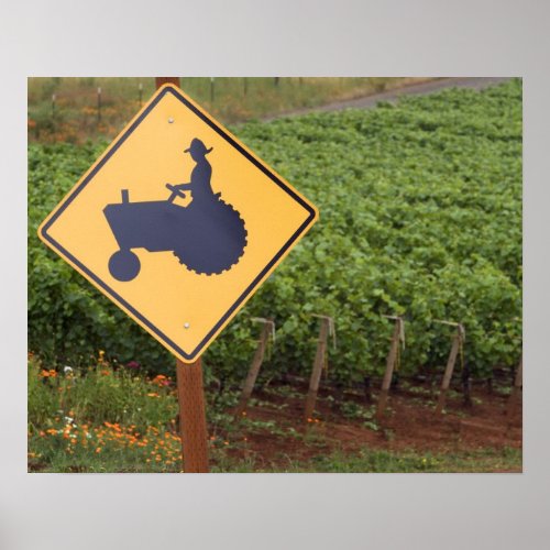 A yellow tractor crossing sign in the vineyard