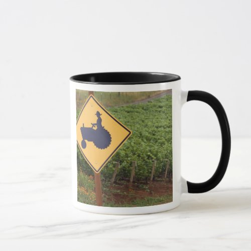 A yellow tractor crossing sign in the vineyard mug