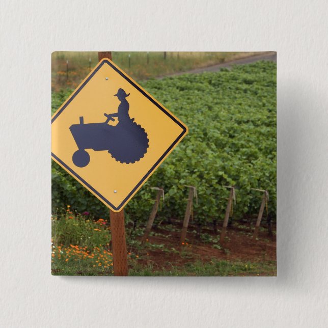 A yellow tractor crossing sign in the vineyard pinback button (Front)