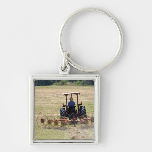 A young boy driving a tractor harvesting keychain (Front)