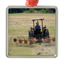 A young boy driving a tractor harvesting metal ornament