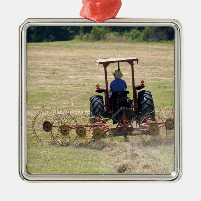 A young boy driving a tractor harvesting metal ornament (Front)