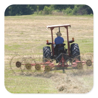 A young boy driving a tractor harvesting square sticker