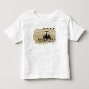 A young boy driving a tractor harvesting toddler t-shirt