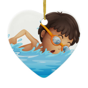 A young boy swimming with a yellow goggles ceramic ornament
