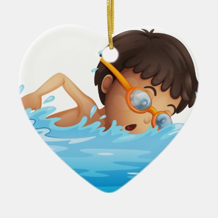 A Young Boy Swimming With A Yellow Goggles Ceramic Ornament