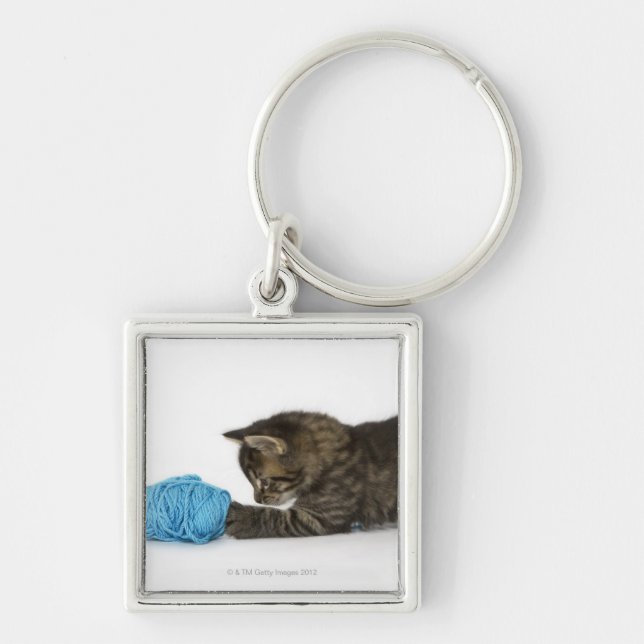 A young Tabby kitten playing with wool. Keychain (Front)