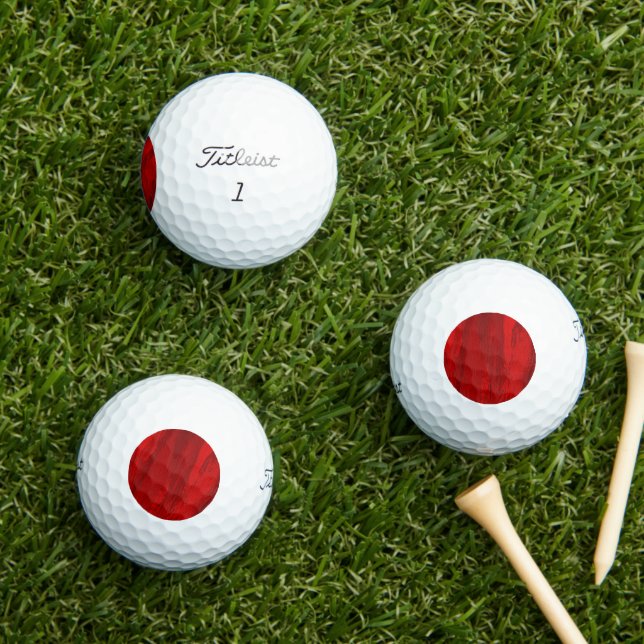 Abstract diagonal shades of red design golf balls (Insitu Grass)