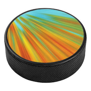 Abstract red yellow orange green stripes on blue hockey puck