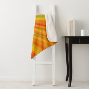 Abstract red yellow orange green stripes on blue sherpa blanket