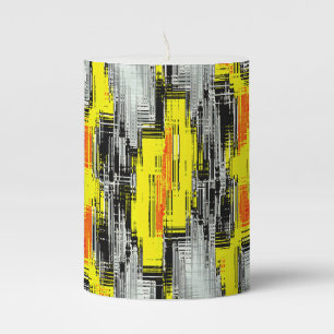 Abstract squares formed from scratches over yellow pillar candle
