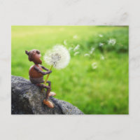 Acorn elf blows into dandelion