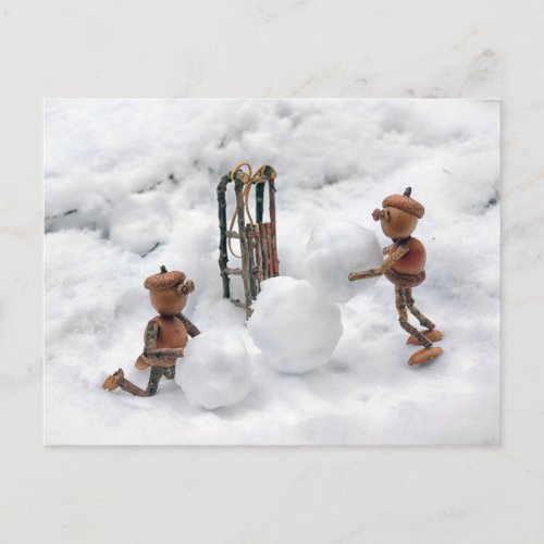 Acorn elves building a snowman winter postcard