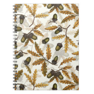 Acorns and oak leaves on off white notebook