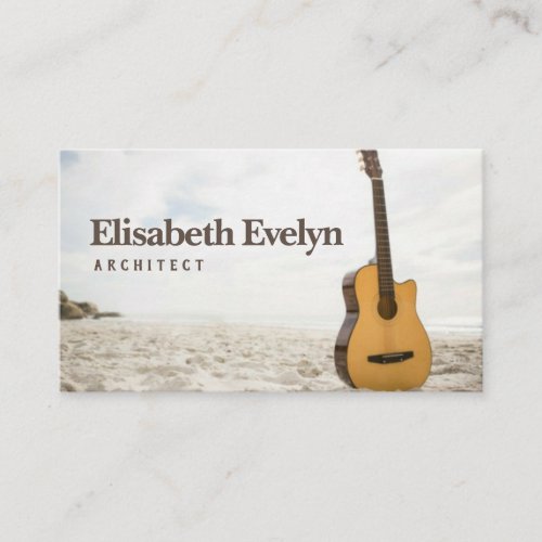 Acoustic guitar standing in the sand business card