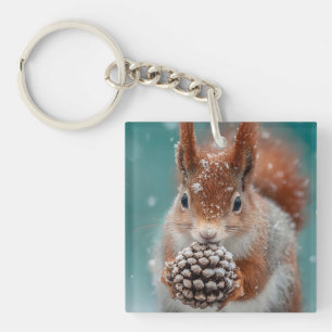 Adorable Red Squirrel in the Snow with a Pinecone Keychain