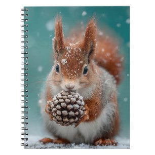 Adorable Red Squirrel in the Snow with a Pinecone Notebook