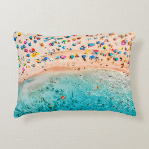 Aerial view of sandy beach with colorful umbrellas accent pillow