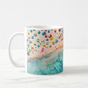 Aerial view of sandy beach with colorful umbrellas coffee mug