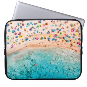 Aerial view of sandy beach with colorful umbrellas laptop sleeve