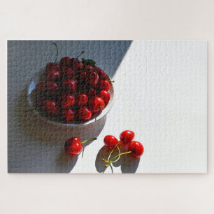 Aesthetic still life with ripe cherries on a white jigsaw puzzle