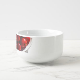 Aesthetic still life with ripe cherries on a white soup mug