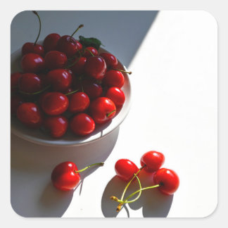 Aesthetic still life with ripe cherries on a white square sticker