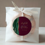 Agate Emerald Green Gold Script Burgundy Wedding Classic Round Sticker<br><div class="desc">This elegant modern wedding sticker features an emerald green watercolor agate geode design trimmed with faux gold glitter. Easily customize the gold-colored text on a burgundy background,  with the names of the bride and groom in handwriting calligraphy over a large ampersand.</div>