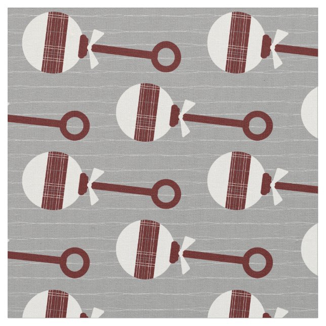 Aggie Maroon Plaid Baby Rattle on Gray Fabric (Close Up)