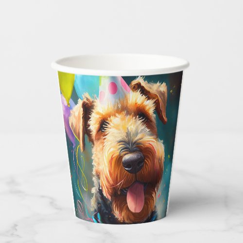 Airedale dog with birthday hat and balloons paper cups