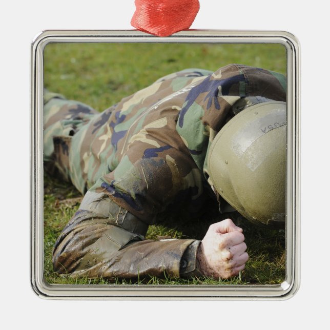 Airman crawls through a wet field metal ornament (Front)