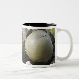 Airman crawls through a wet field Two-Tone coffee mug